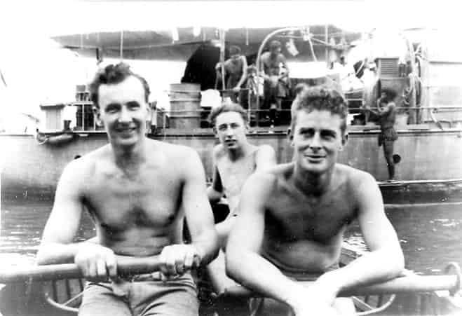 Alistair Knox  (right) resting on the oars in New Guinea during the war. The Martinadale in the background