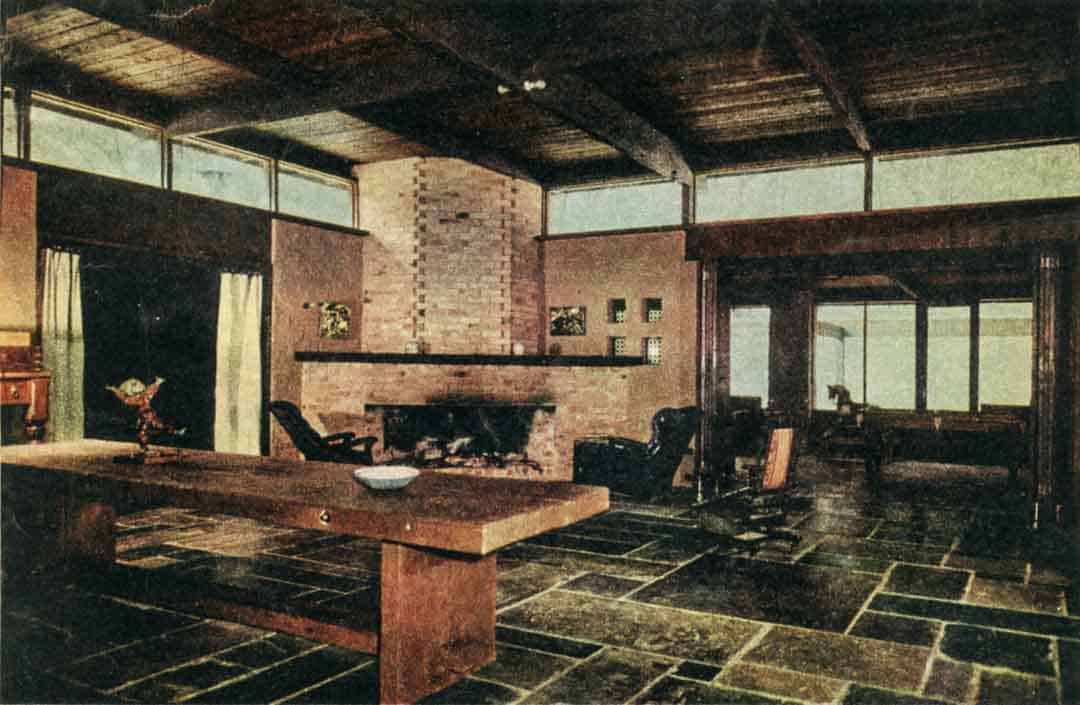 The central courtyard room (below). Earthen walls, rough-timbered ceilings, adzed timber table and benches, slate and prick floors (set directly on to the earth, and drawing a natural warmth from it), all combine to import a 'hewn' character to the house. There's little to impede the internal flow of spaces here. Between the two main rooms, a folding door (made of discarded church pew backs) can be flung wide open, and the space leading to the main bedroom and kitchen (left) is covered by a soft leather curtain which gives the visual weight of a door without its 'finality'.