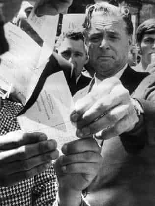 Dr Jim Cairns burns a draft card in the Melbourne Civic Square during a November 1969 protest. Picture: HWT Library