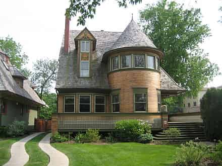 The Walter Gale House, Oak Park, Illinois (1893). While a Queen Anne in style, it features window bands and a cantilevered porch roof which hint at Wright's developing aesthetics